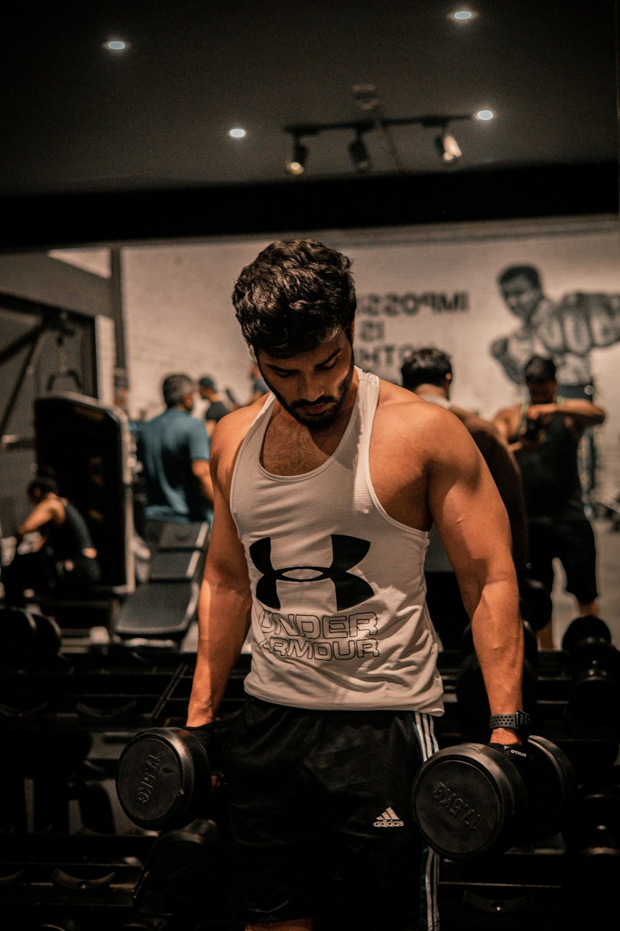 Focused athlete working with dumbbells in the gym